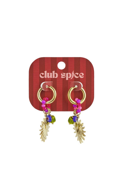 Golden-toned hoop earrings featuring dangling colorful beads and gold sunburst heart charms on a red Club Spice card.