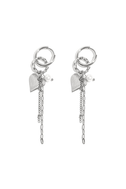 Pair of silver dangle hoop earrings with heart charms, pearls, and multiple chains on white background