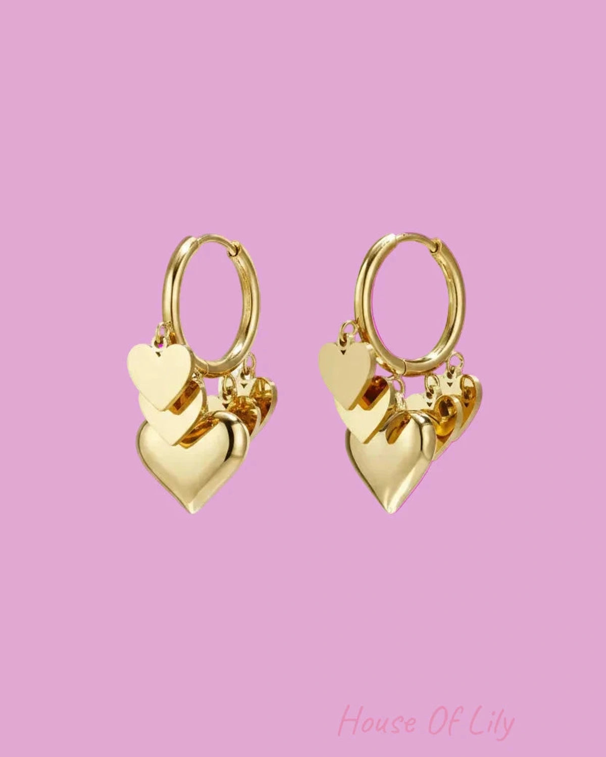 Gold heart-shaped hoop earrings on a white background