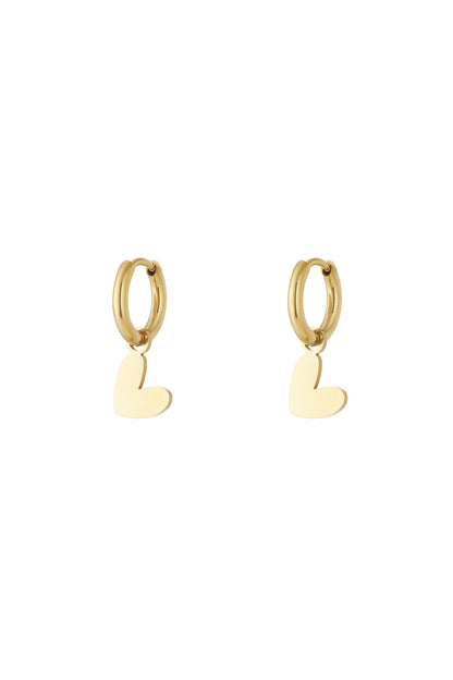 Pair of polished gold heart drop earrings with smooth hoops on plain white background