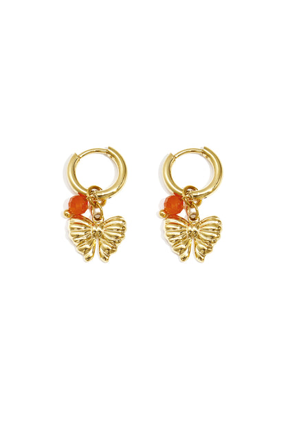 Pair of gold hoop earrings with butterfly charms and vibrant orange beads on white background