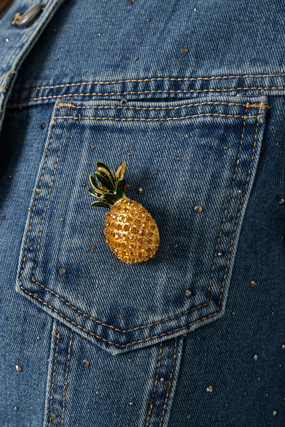 Sparkling pineapple brooch pinned on blue denim jacket pocket decorated with small rhinestones