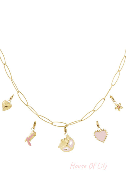 Close-up view of a gold link necklace featuring five charms: heart, floral, pink boot, masquerade mask, and pink heart enamel