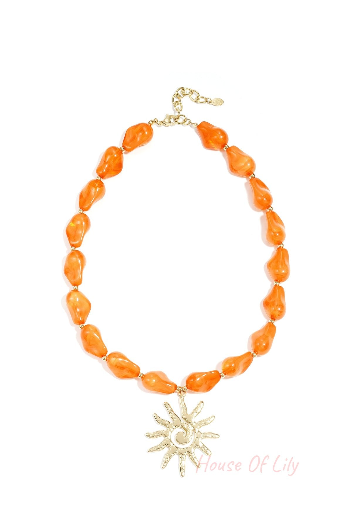 Vibrant orange acrylic beaded necklace with a textured gold sun pendant shown on a white background