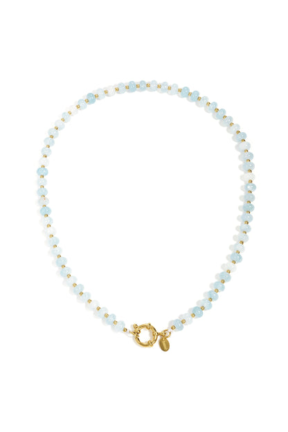 Close-up of a beige and tan stone beaded necklace with gold beads and toggle clasp