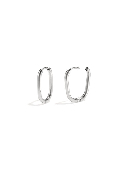 Pair of polished silver oval hoop earrings with snap closure on white background
