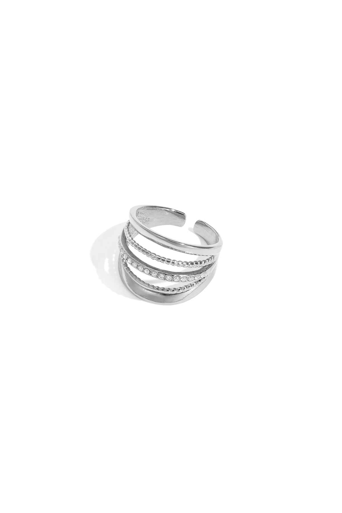 Close-up of adjustable silver-tone layered statement ring with rhinestones on white background