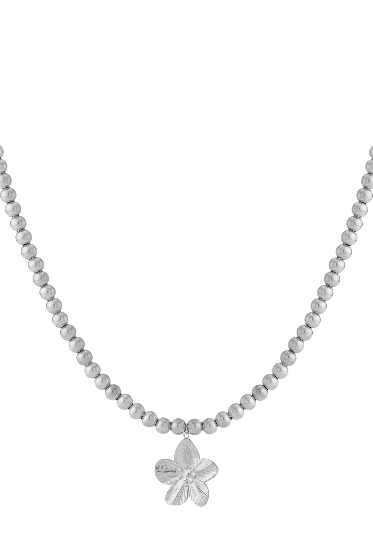 Close-up of silver beaded necklace with flower pendant on white background