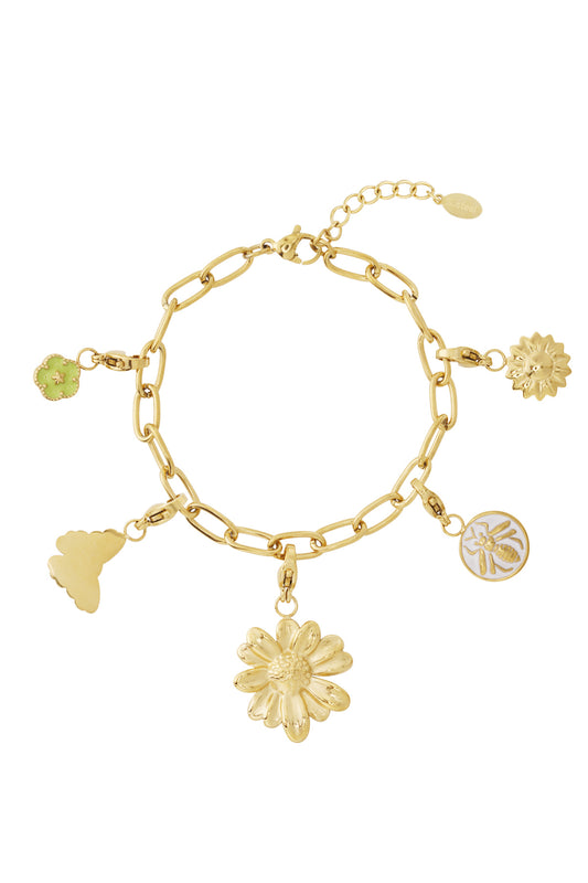 Close-up of gold charm bracelet with detachable floral and insect charms showing detailed design and lobster clasps on a white background
