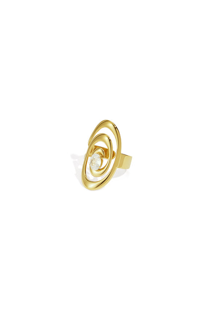 Close-up of a gold spiral ring with a sparkling gemstone center on white background