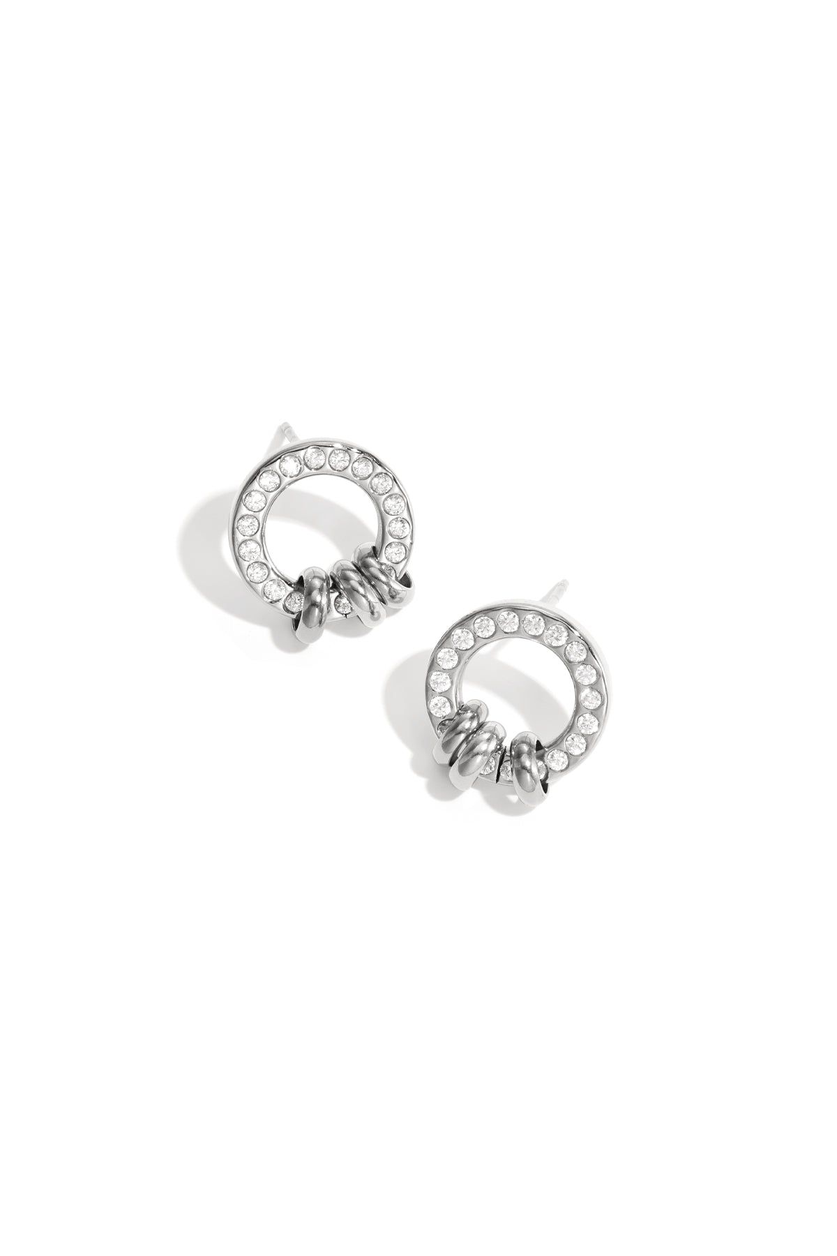 Silver tone circle stud earrings adorned with clear crystals and three small silver loops at the base on white background