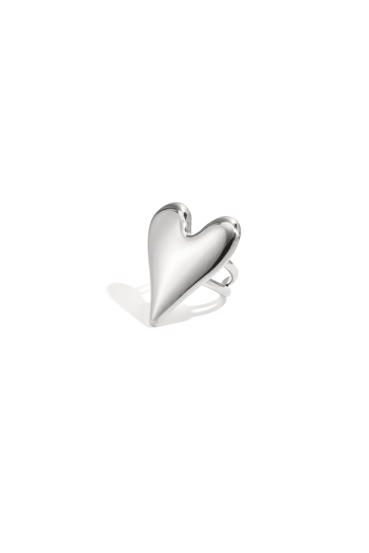 Polished silver-toned statement ring featuring a large puffed heart shape isolated on a white background