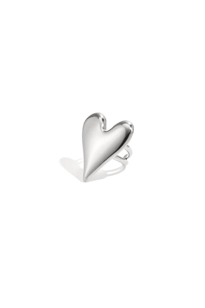 Polished silver-toned statement ring featuring a large puffed heart shape isolated on a white background