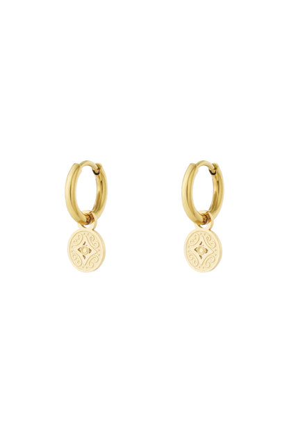 Gold-tone stainless steel hoop earrings with engraved round charm detail on white background