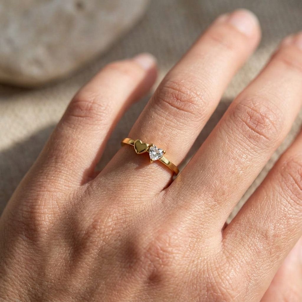Close-up of a heart rhinestone ring on a slender finger, showing its subtle sparkle and delicate design with soft natural lighting.
