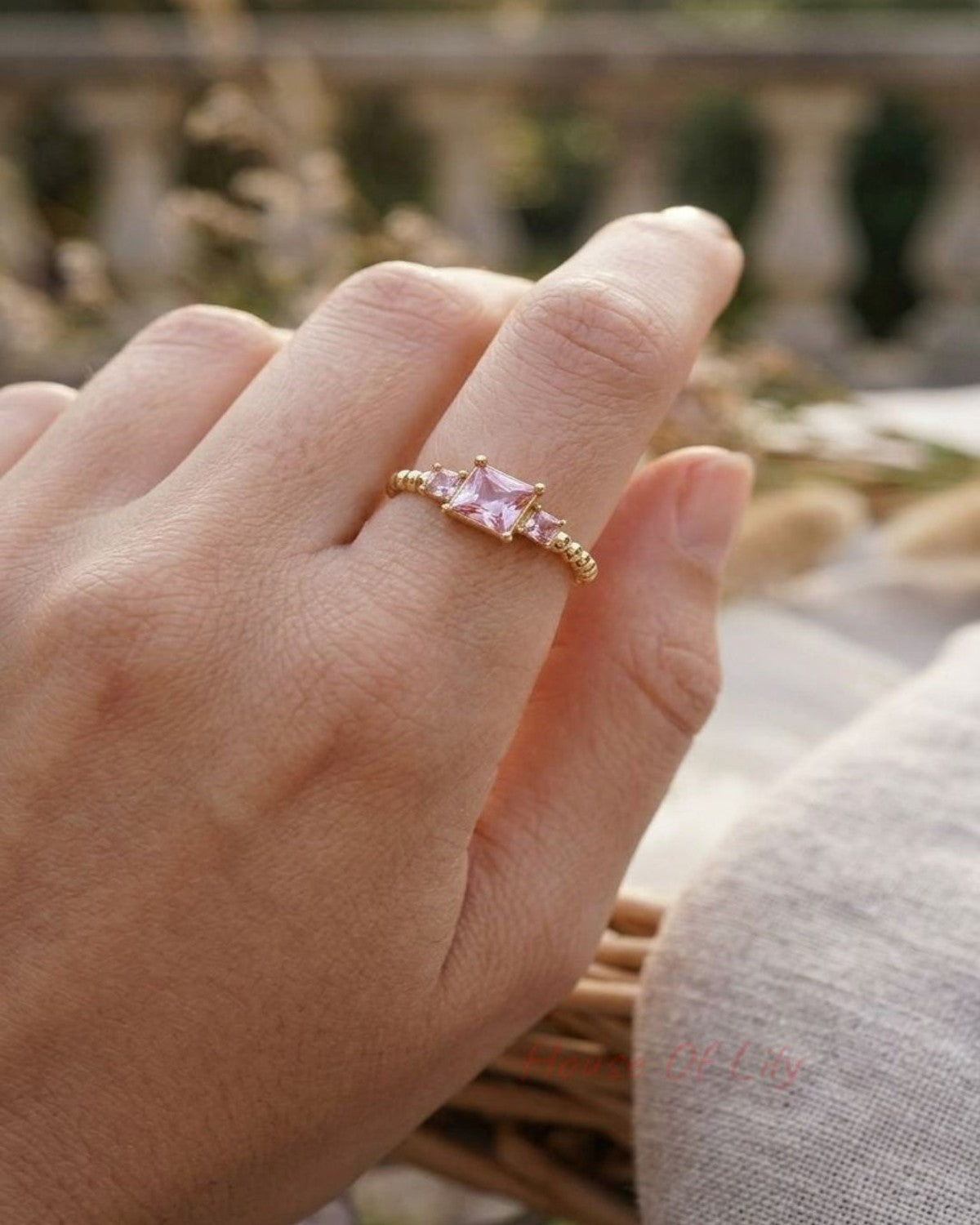 Y2K Square Gem gold ring on a slender finger in an outdoor setting, showcasing its geometric silhouette and subtle elegance.
