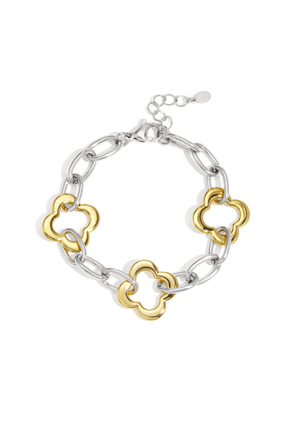 Two-tone chain bracelet with silver links and gold clover-shaped links displayed on white