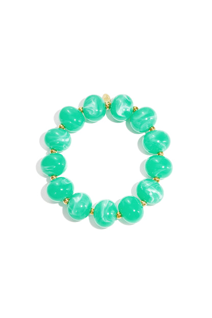 Green marbled beaded stretch bracelet with gold spacer beads on white background