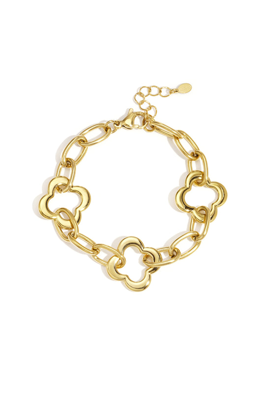 Gold chain link bracelet with three clover-shaped links laid flat on white background