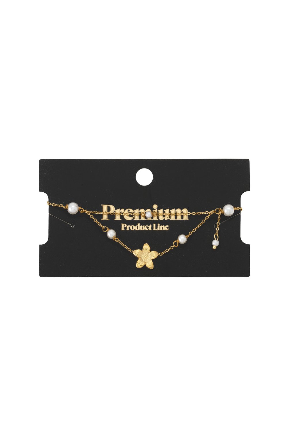 Layered gold chain bracelet featuring a delicate floral charm and white pearl accents on a black display card.