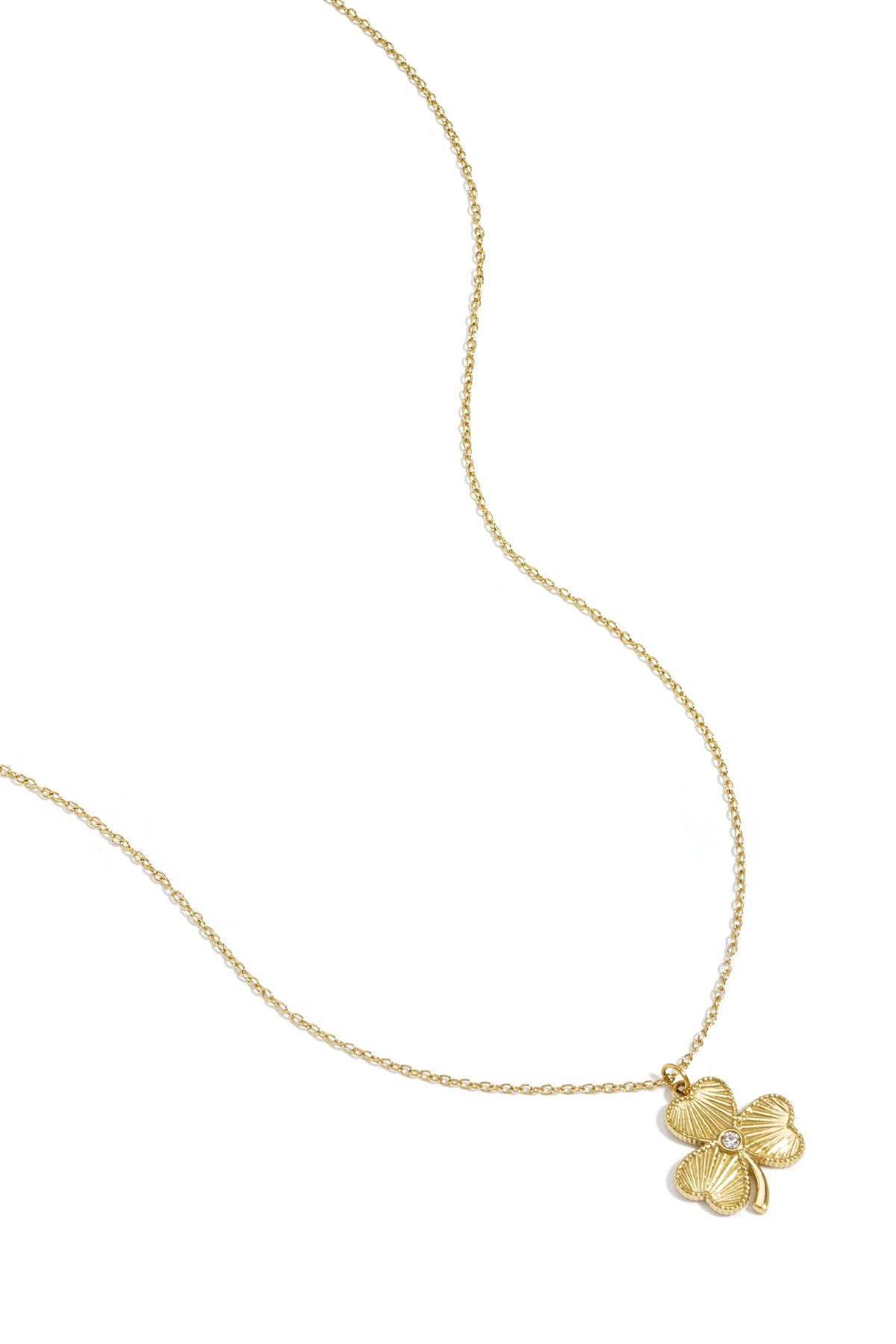 Gold clover pendant necklace with delicate chain laying flat on a white background