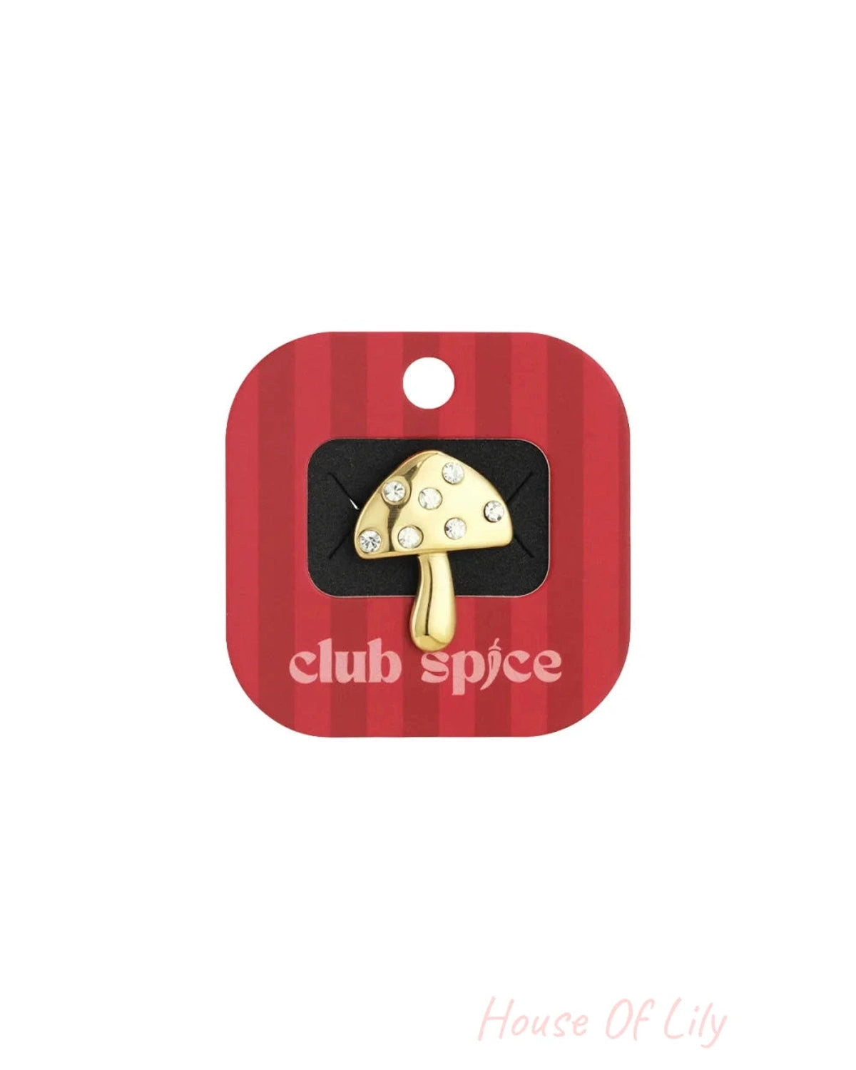 Gold mushroom pin with crystal accents, displayed on a red and white striped backing.
