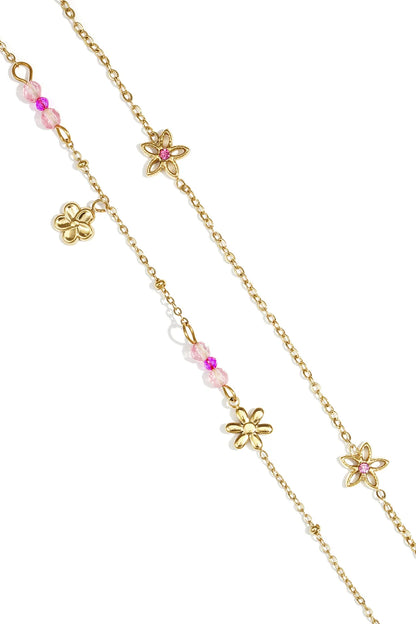 House of Lily gold layered bracelet featuring daisy charms and delicate pink crystal beads on a dainty chain.