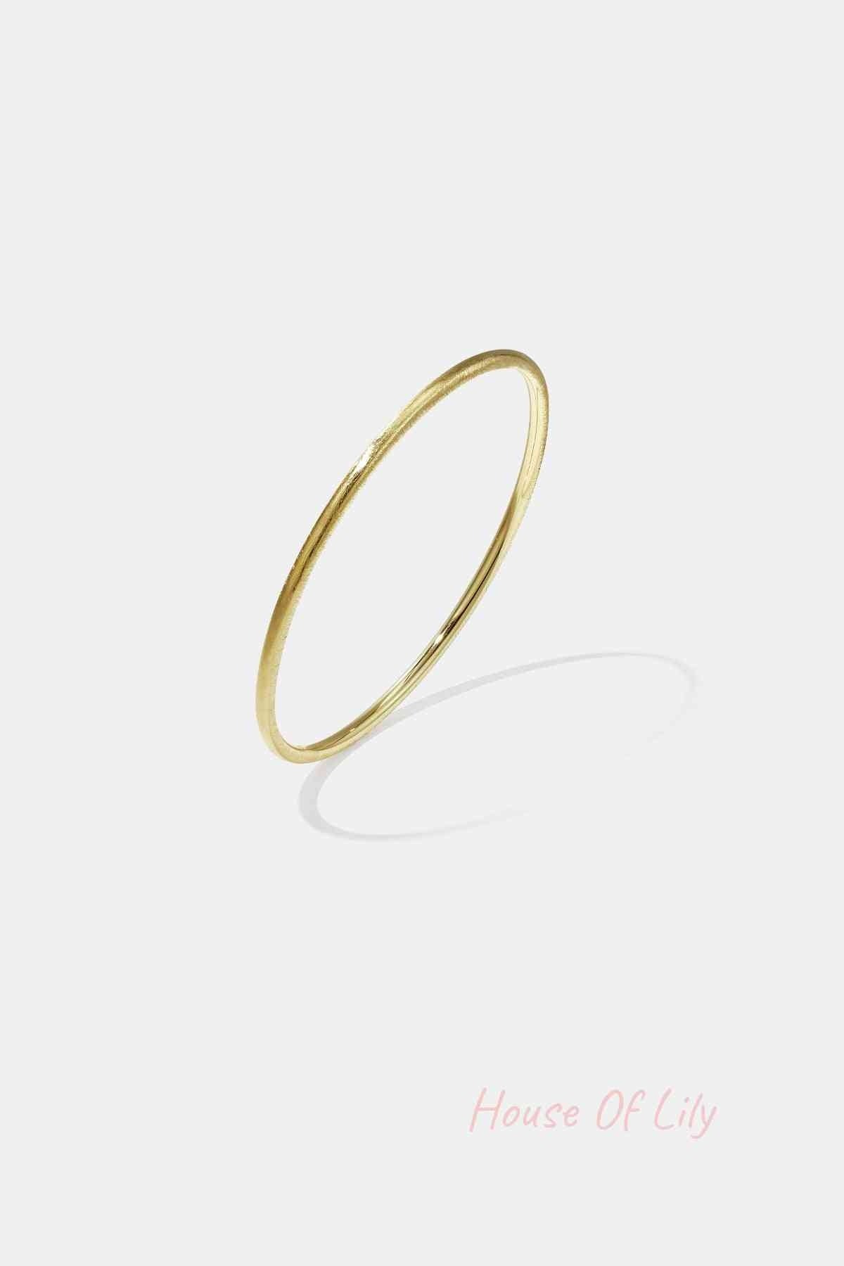 Minimalist gold 3mm circle bangle bracelet on white background