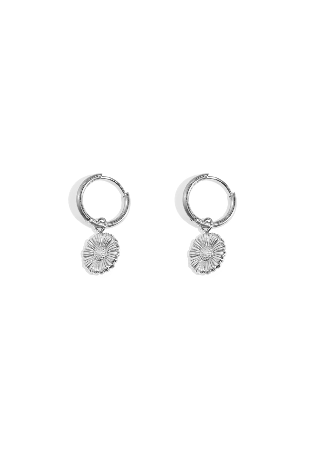 Pair of silver floral charm hoop earrings on white background