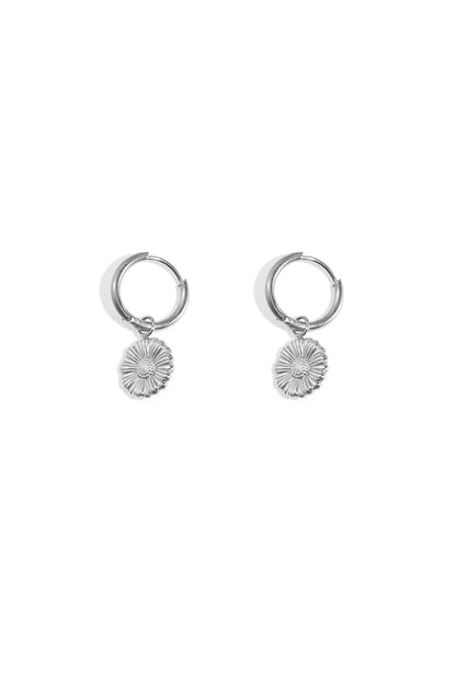 Pair of silver floral charm hoop earrings on white background