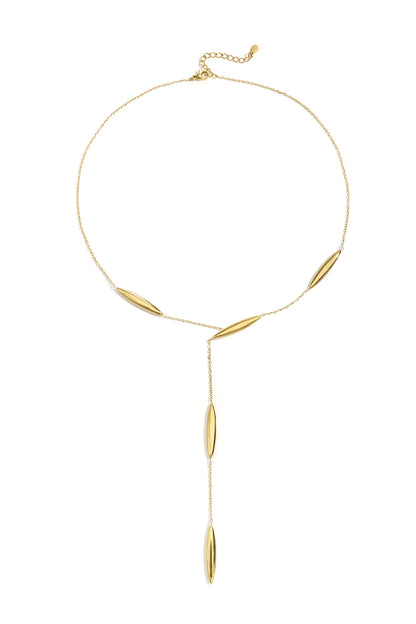 Gold Y-shaped chain necklace with elongated smooth beads and adjustable length laid flat on a white background
