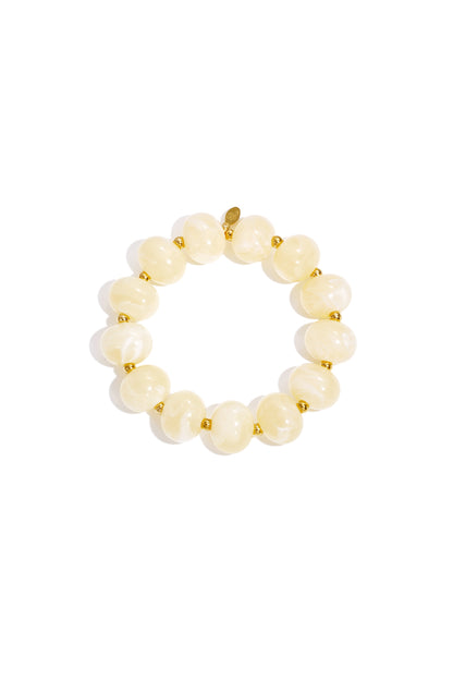 Cream marbled beaded stretch bracelet with gold accent spacer beads on white background