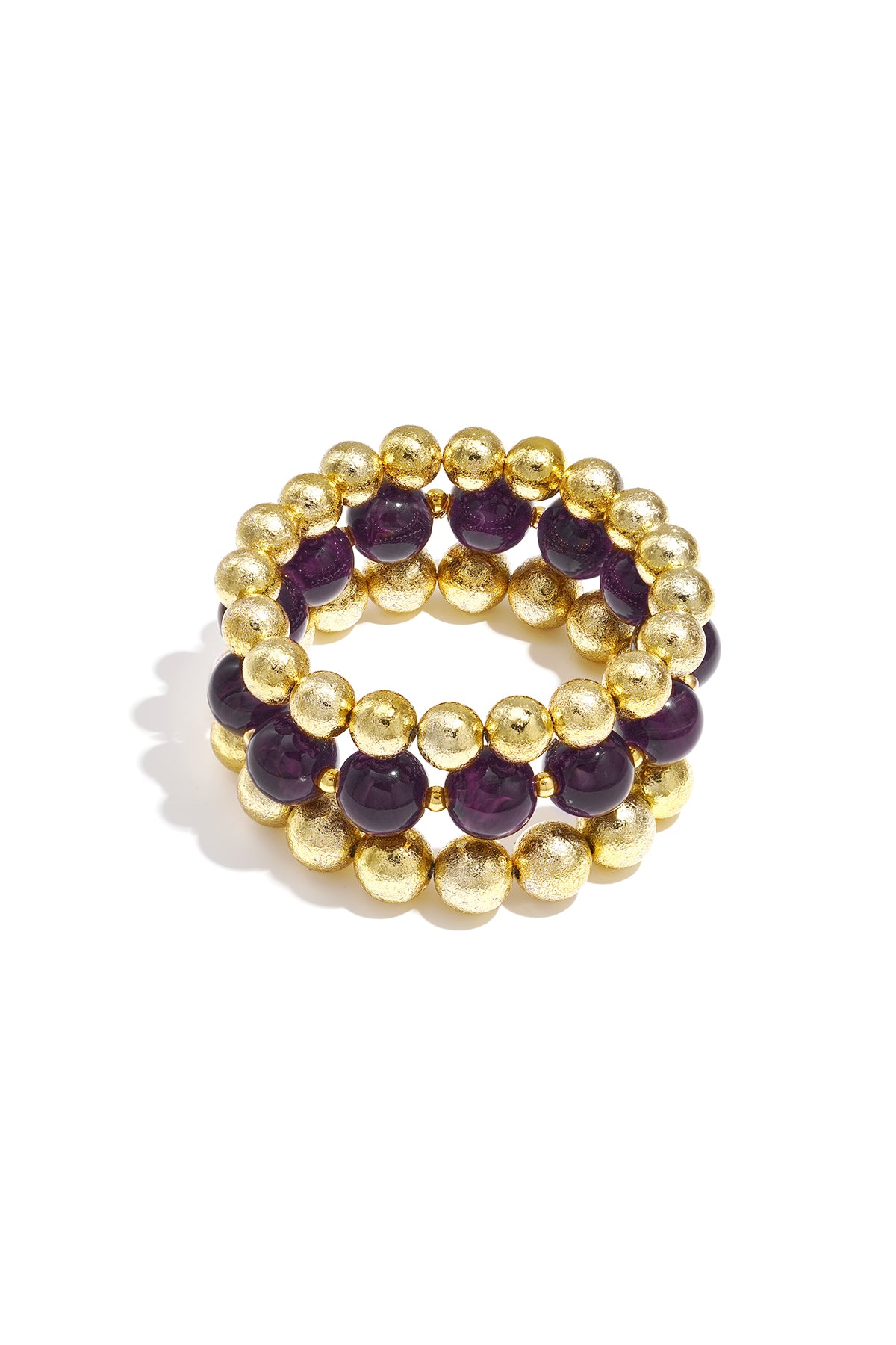 Set of three beaded bracelets with purple marbled beads and textured gold spheres on white background