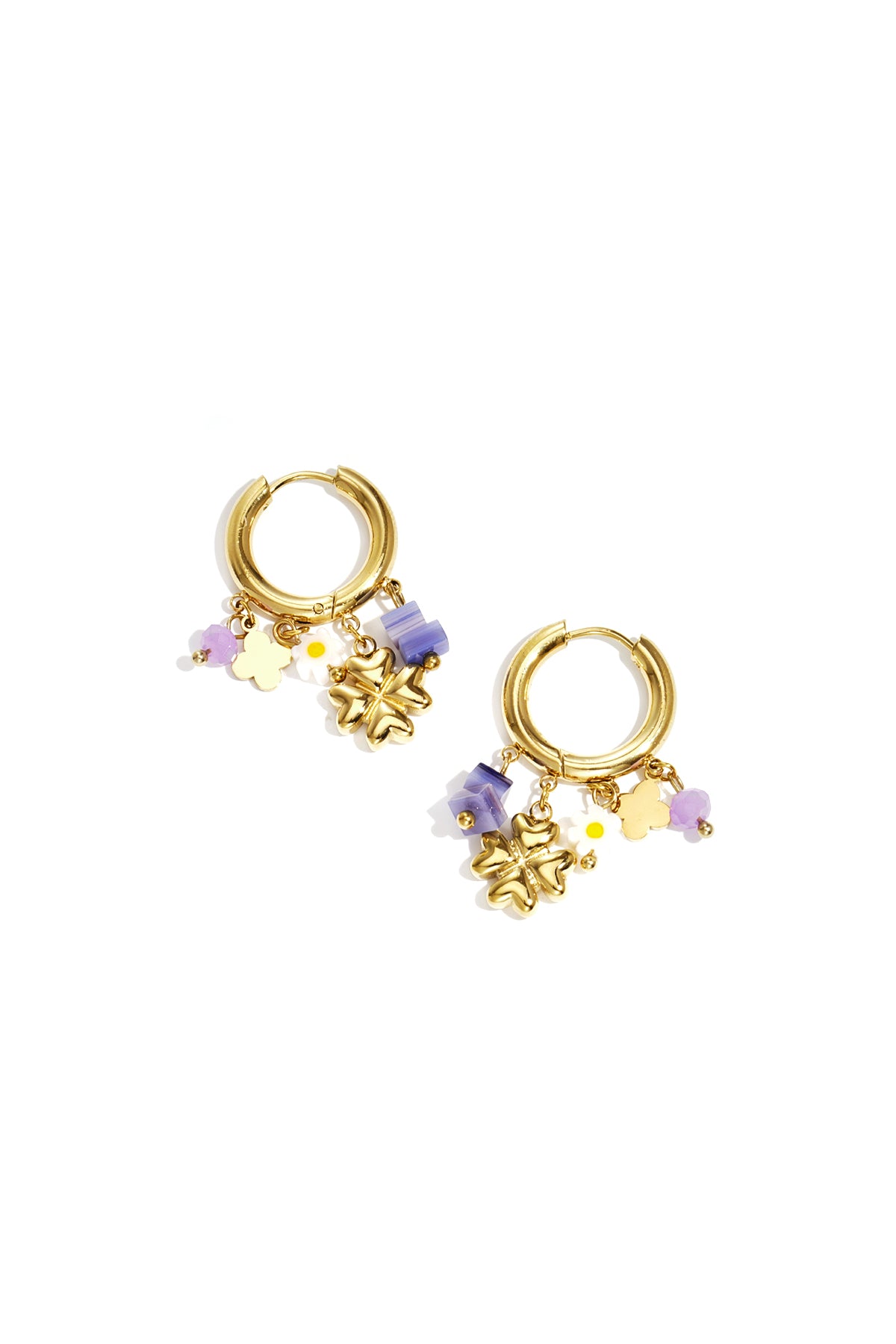 Pair of gold hoop earrings with purple, white, and gold clover and flower charms on white background
