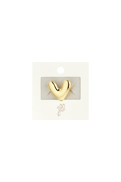 Gold chubby heart-shaped statement ring displayed on branded jewelry card packaging