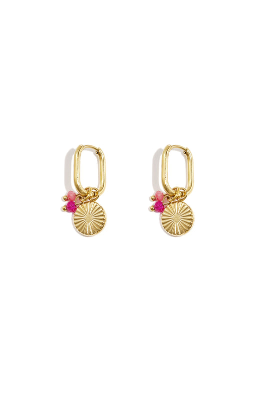 Pair of gold rectangular hoop earrings with sunflower charm and pink beads on white background
