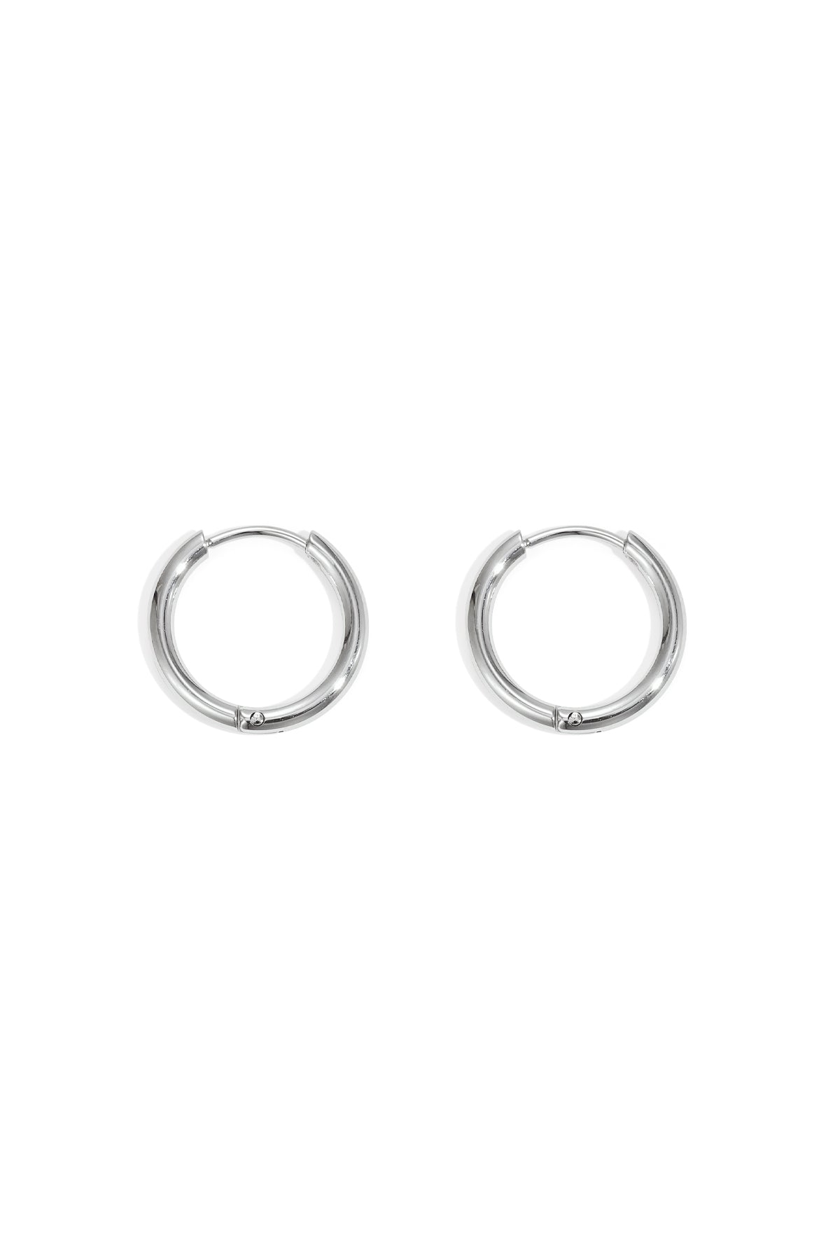 Pair of small silver hoop earrings with smooth rounded design set on a white background