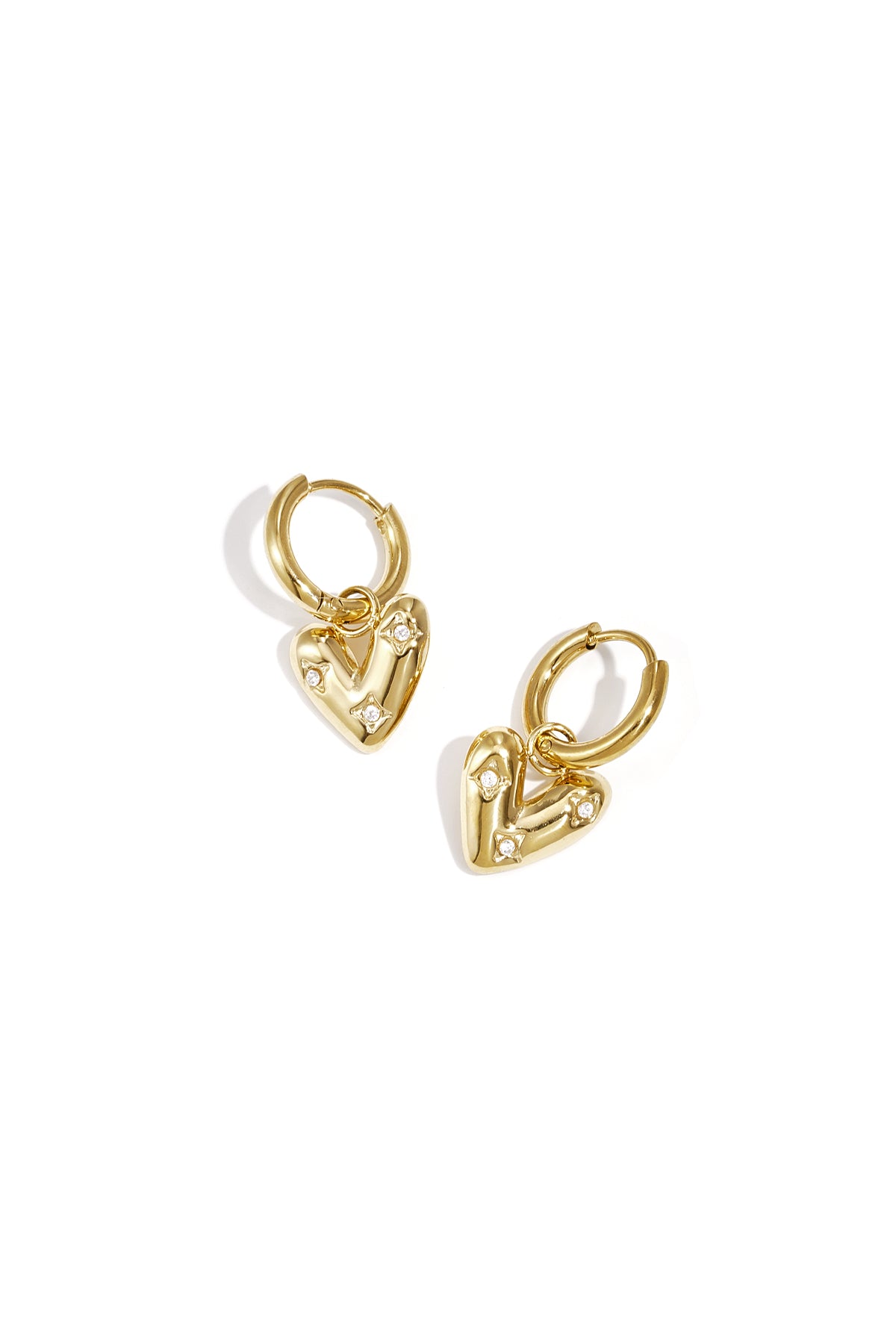 Gold heart charm hoop earrings with small zirconia stones on a white background