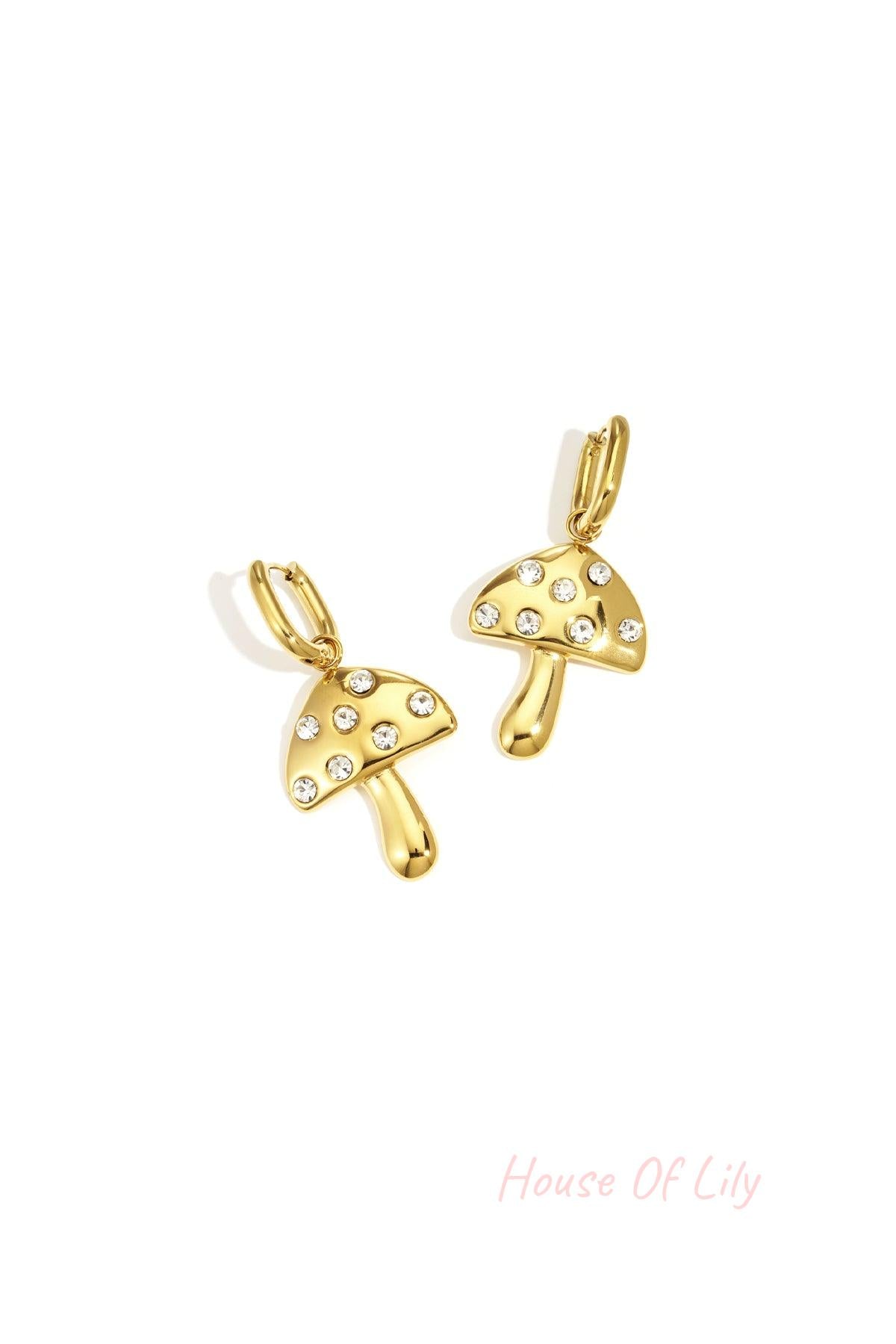 Gold mushroom drop earrings with clear rhinestone dots on a white background
