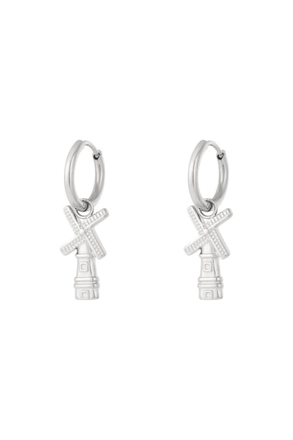 Pair of silver windmill charm hoop earrings with detailed blades on white background