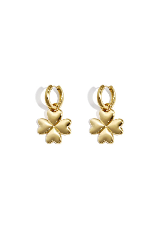 Pair of gold four-leaf clover hoop earrings with heart-shaped petals on white background