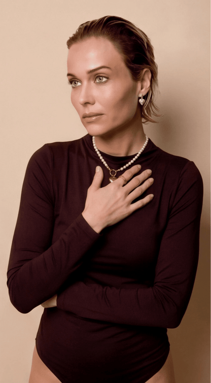 Model wearing Coquette Heart Hoops, small silver heart-shaped pendant earrings in a romantic, dainty style.