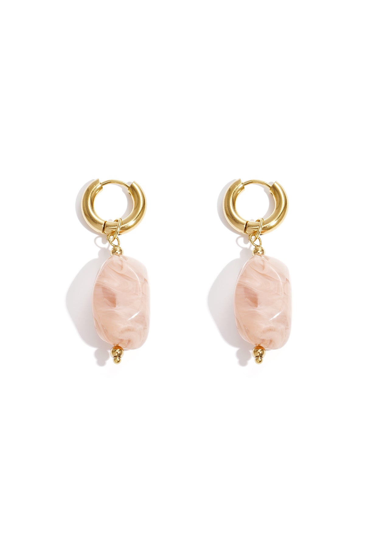 Gold hoop earrings with irregular off-white resin drop beads on white background