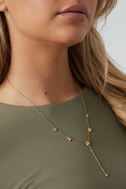 Detailed shot of the star and heart pendant necklace showing rhinestone embellishments on a woman's neckline