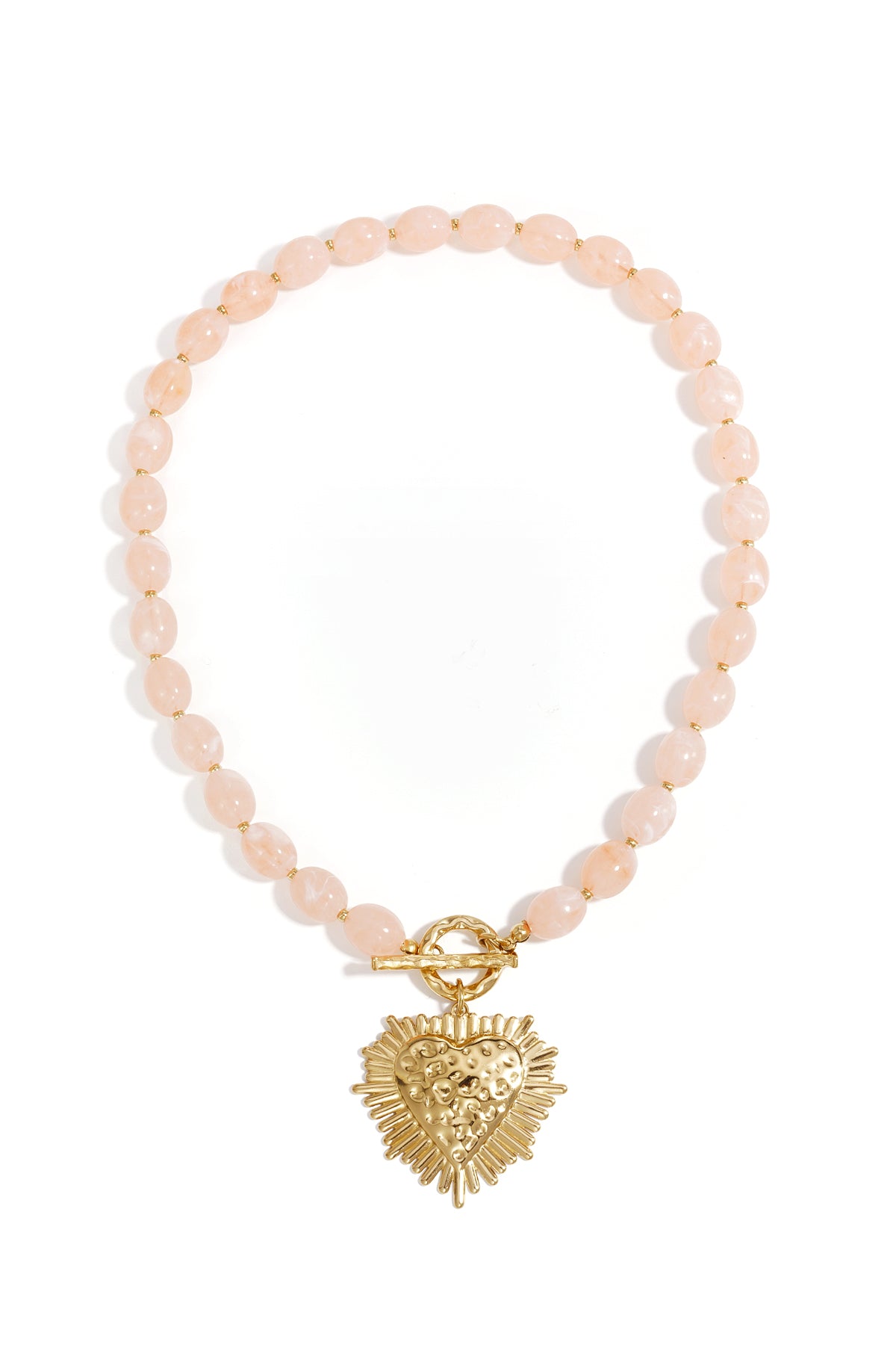 chic beaded necklace with nude beige oval beads and gold textured heart pendant with toggle clasp