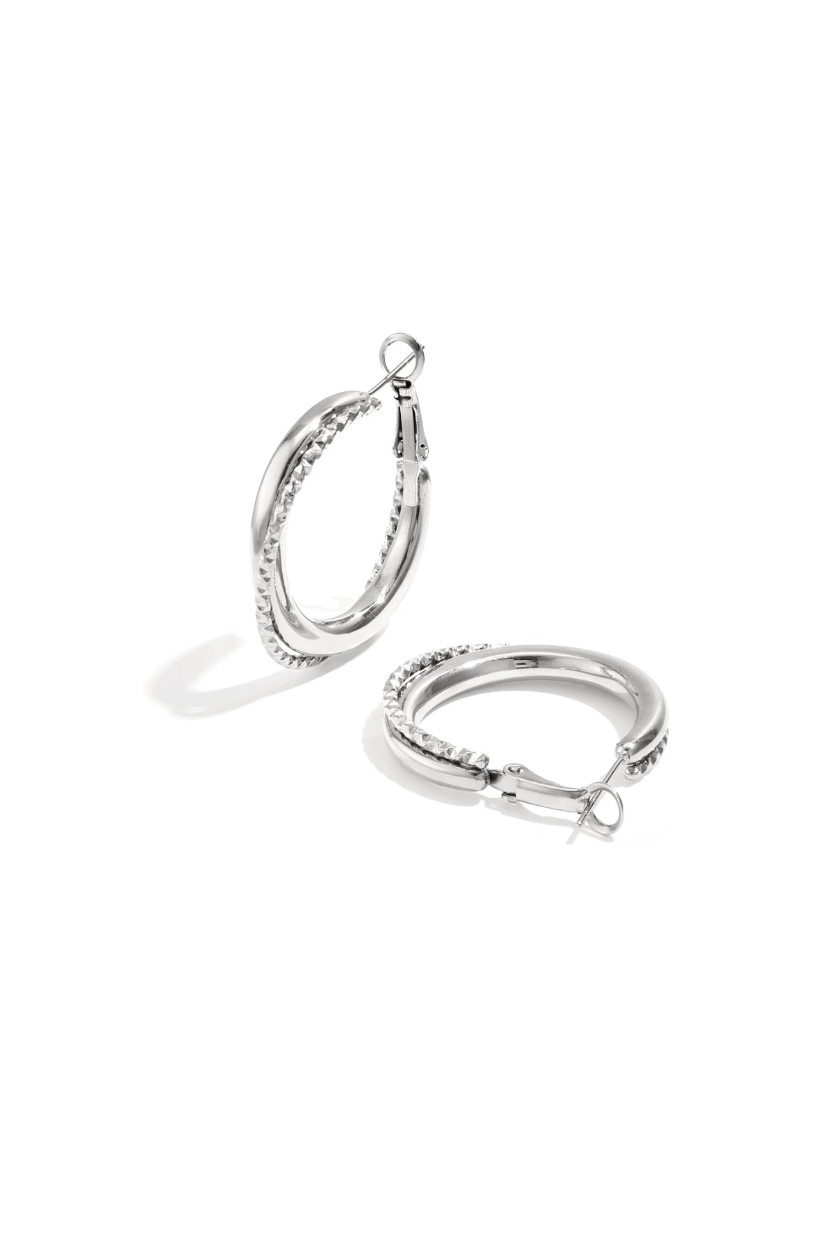 Silver twisted double hoop earrings featuring mixed polished and textured design, displayed on white background.