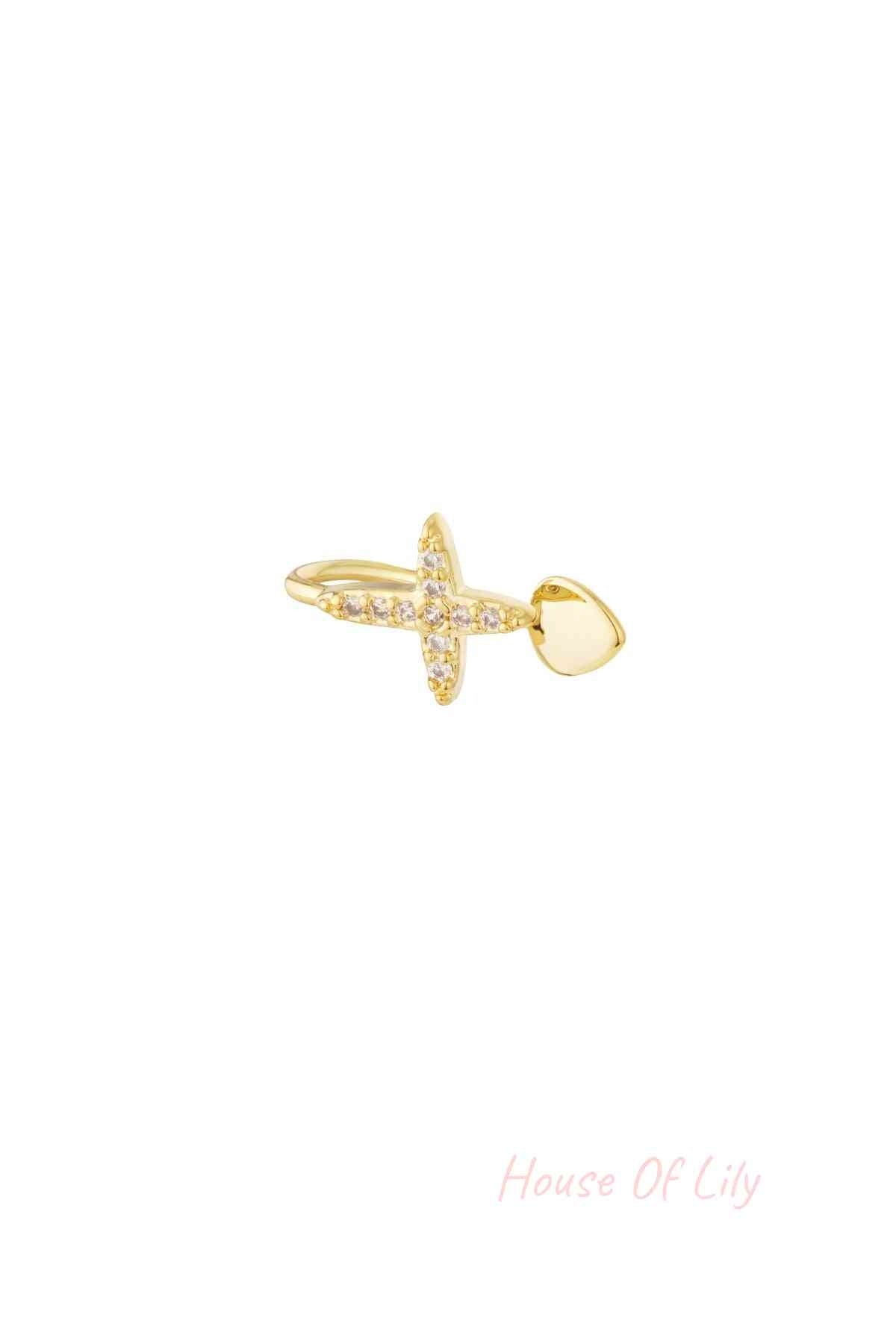 Close-up of gold nose and ear cuff featuring a cross adorned with clear cubic zirconia stones and a smooth heart-shaped end