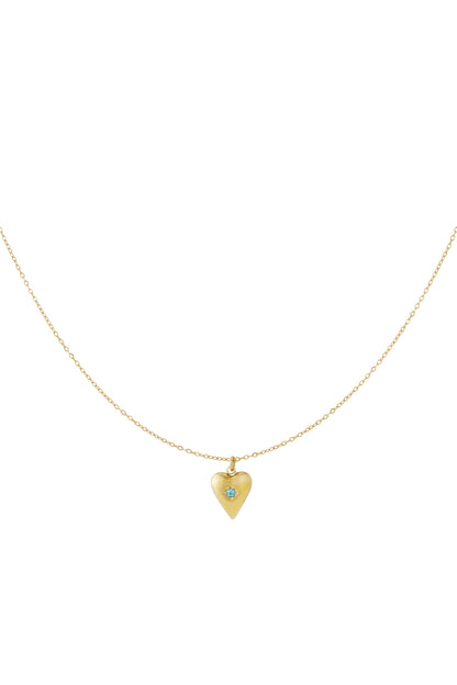 Gold heart pendant necklace with bright blue birthstone displayed on white background