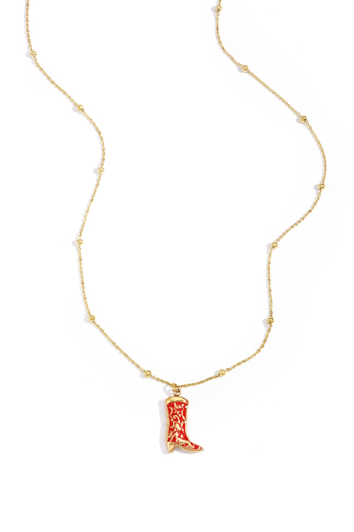 Gold chain necklace with small beads and a red cowboy boot charm pendant on a white background