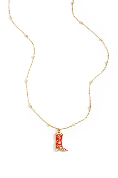 Gold chain necklace with small beads and a red cowboy boot charm pendant on a white background